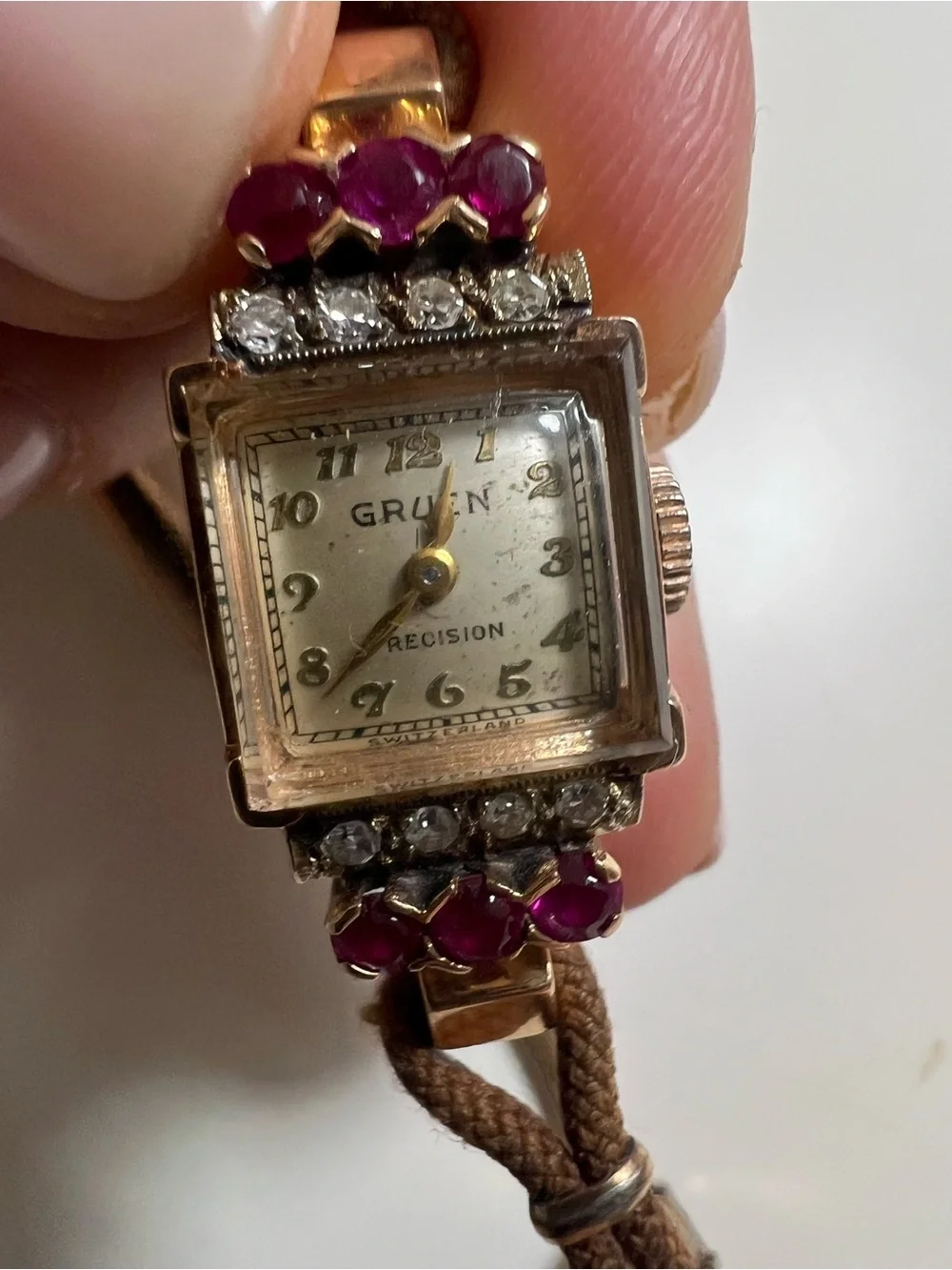 Gruen Precision wristwatch crafted in 14k rose gold with rubies and diamonds